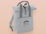 Light grey roll top twin handle backpack with an embroided design of cute crying bear and the quote emotional baggage