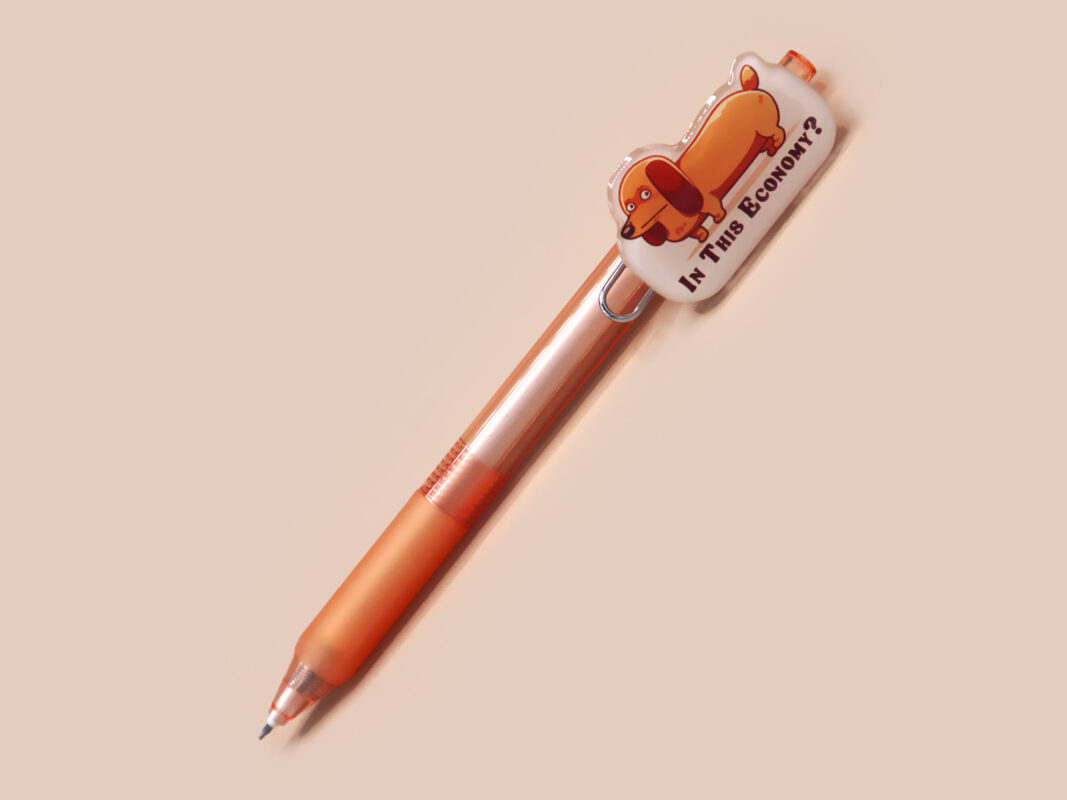 Orange ballpoint pen with black ink and a cute chibi dachshund sausage dog design.