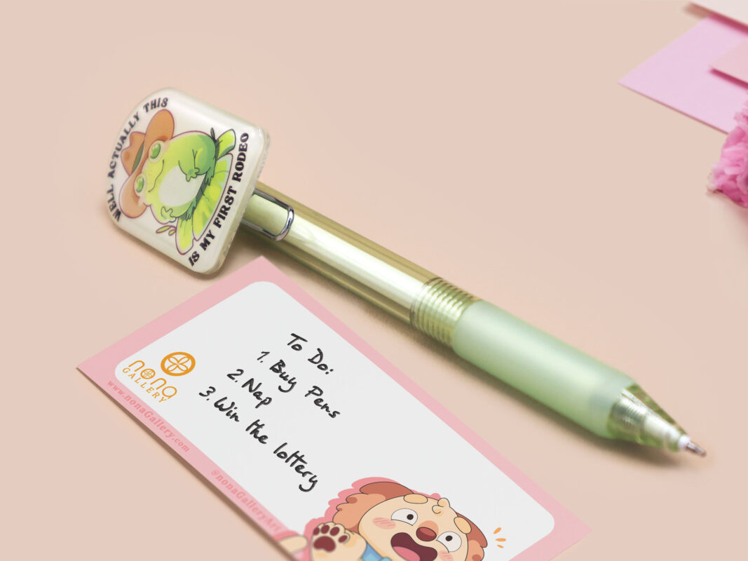 Green ballpoint pen with black ink and a cute chibi cowboy frog design.