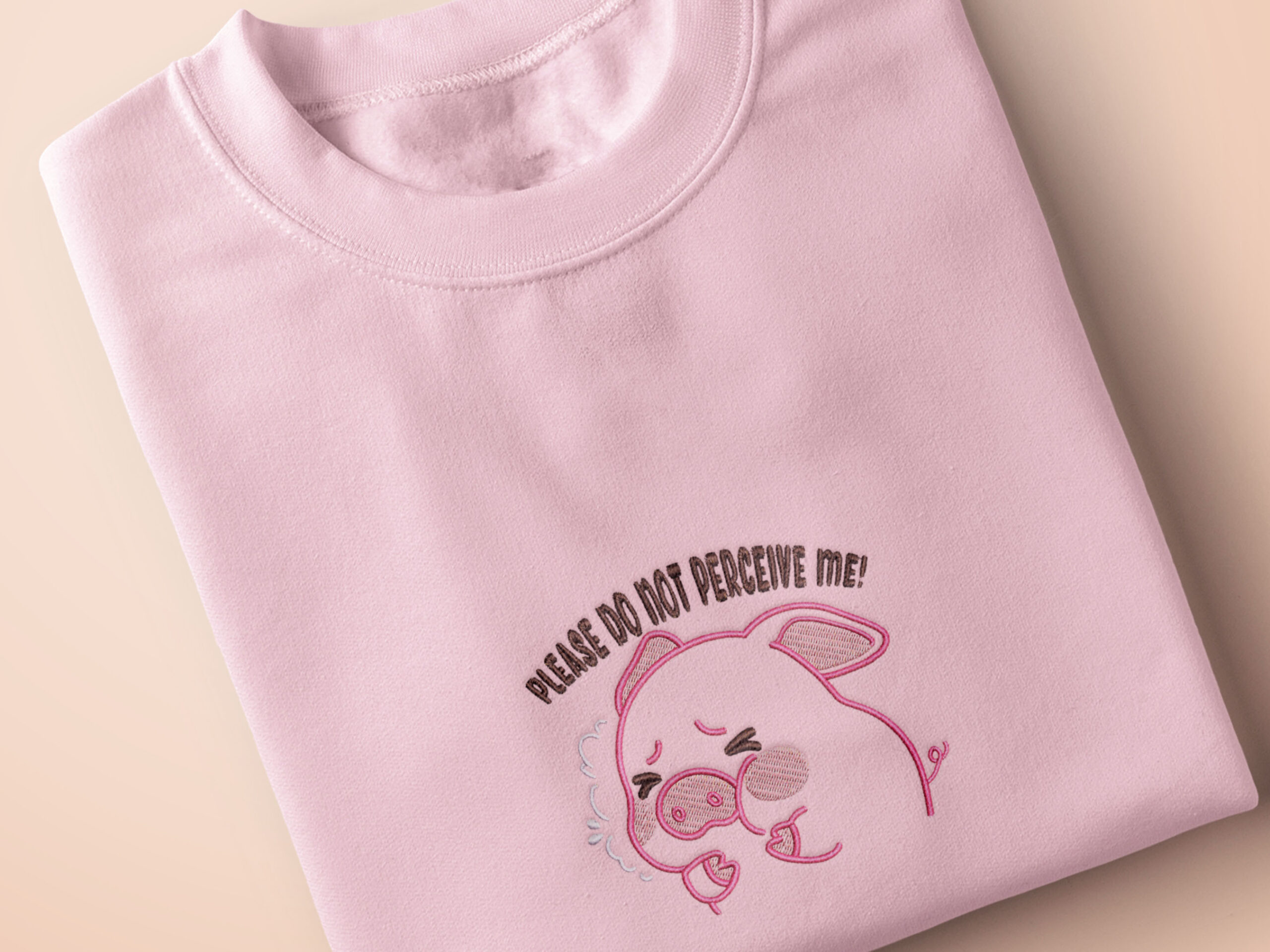 Embroidered Pink Top Tshirt Design Fun Cute Stylish Pig Pink Please Do Not Perceive Me Meme Funny Motif by Nona Gallery Thumbnail 1 Pink embroidered t-shirt with a cute chibi panicking pig surrounded by the quote please don't perceive me