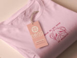 T-shirt with an embroidered Pink Design of a crying chibi hamster with the text what do you mean no dessert?!